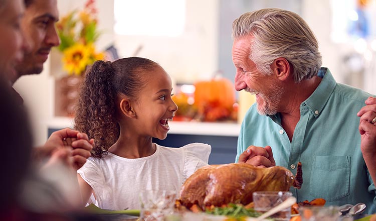 Girl and man at Thanksgiving table