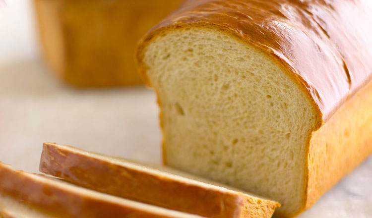 Partially sliced loaf of brioche bread