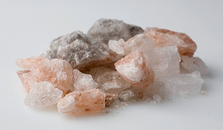 Assorted colors of rock salt on a white background