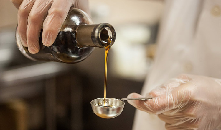 Pouring oil into measuring spoon