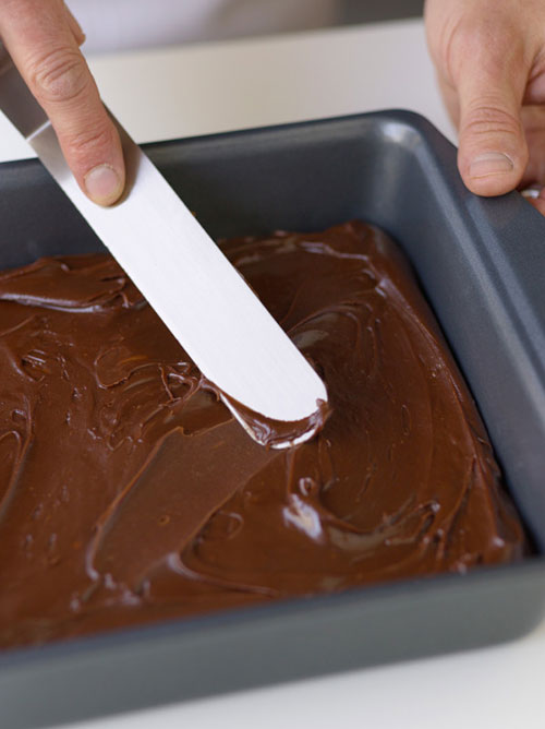 Pour into a buttered pan, spread in an even layer, and allow the fudge to set.