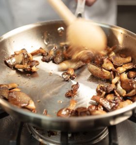 Mushrooms cooking in pan