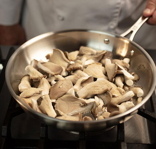 Raw mushrooms in pan