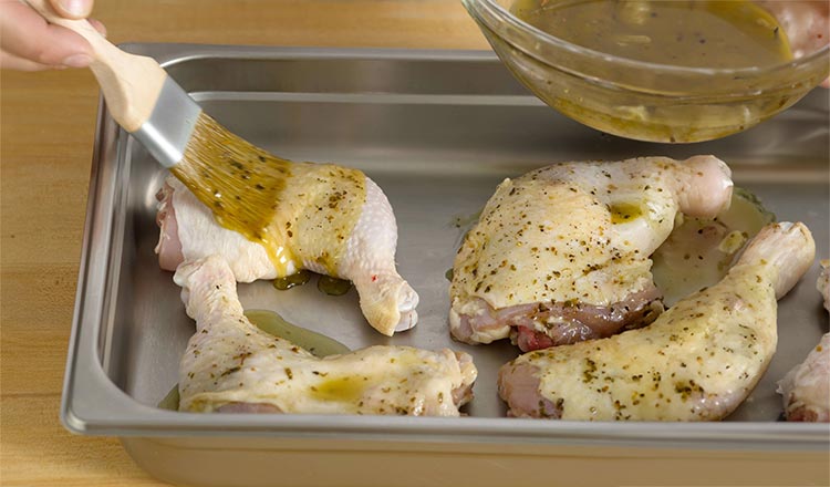 chicken being brushed with marinade