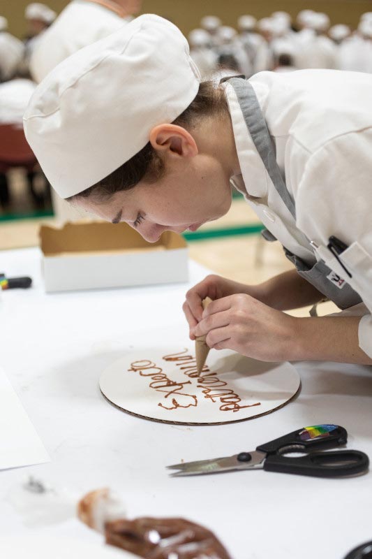 Student piping on a board