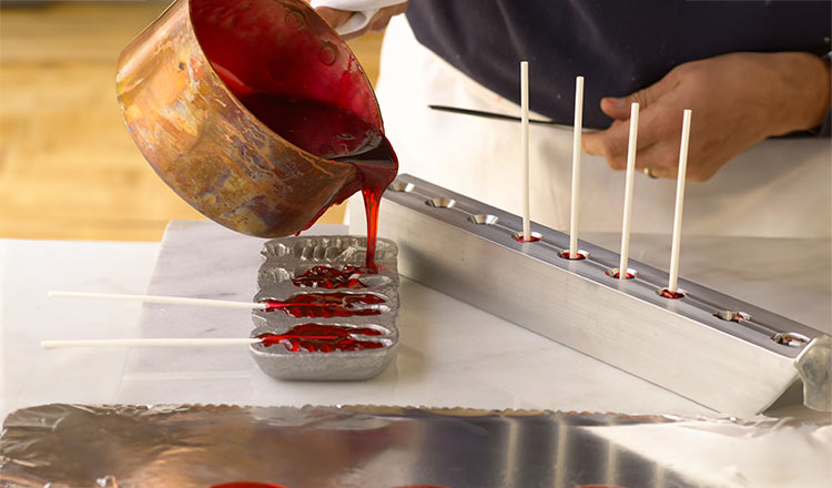 Pouring hot cooked sugar into candy molds