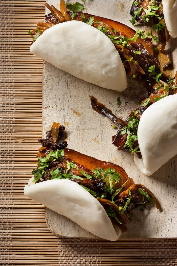Steamed buns with pork and mustard greens