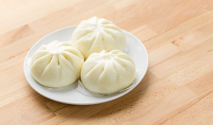 Three Chinese steamed buns on a plate