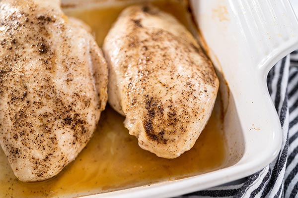 Cooked chicken that has not browned in the oven.
