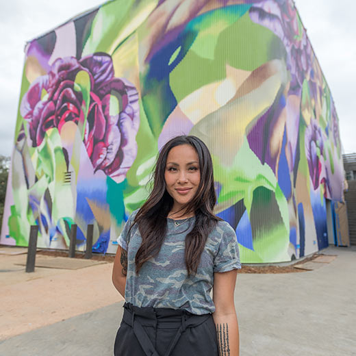 Artist Allison Tinati, who paints under the name “Hueman,” outside her 