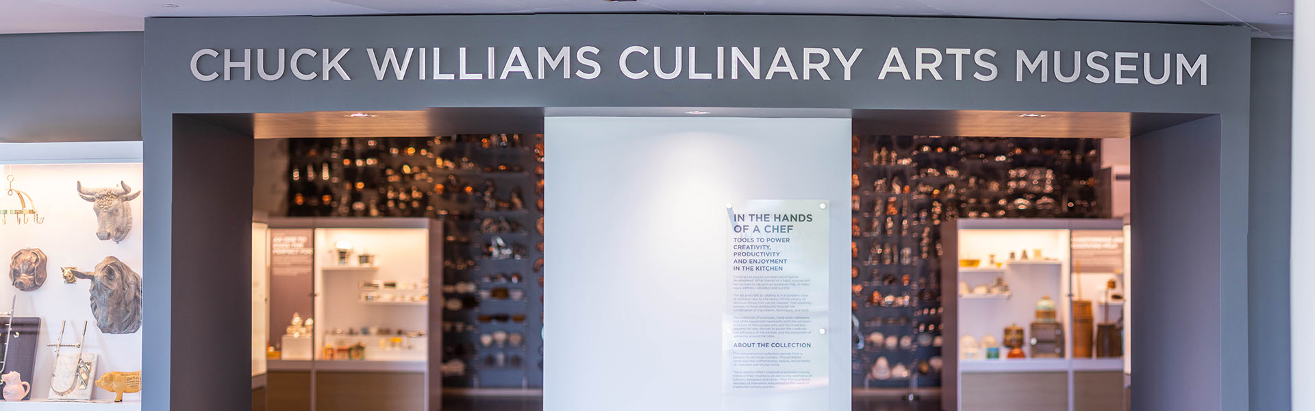 Entrance to Chuck Williams Culinary Arts Museum displaying historic cookware and kitchen tools.