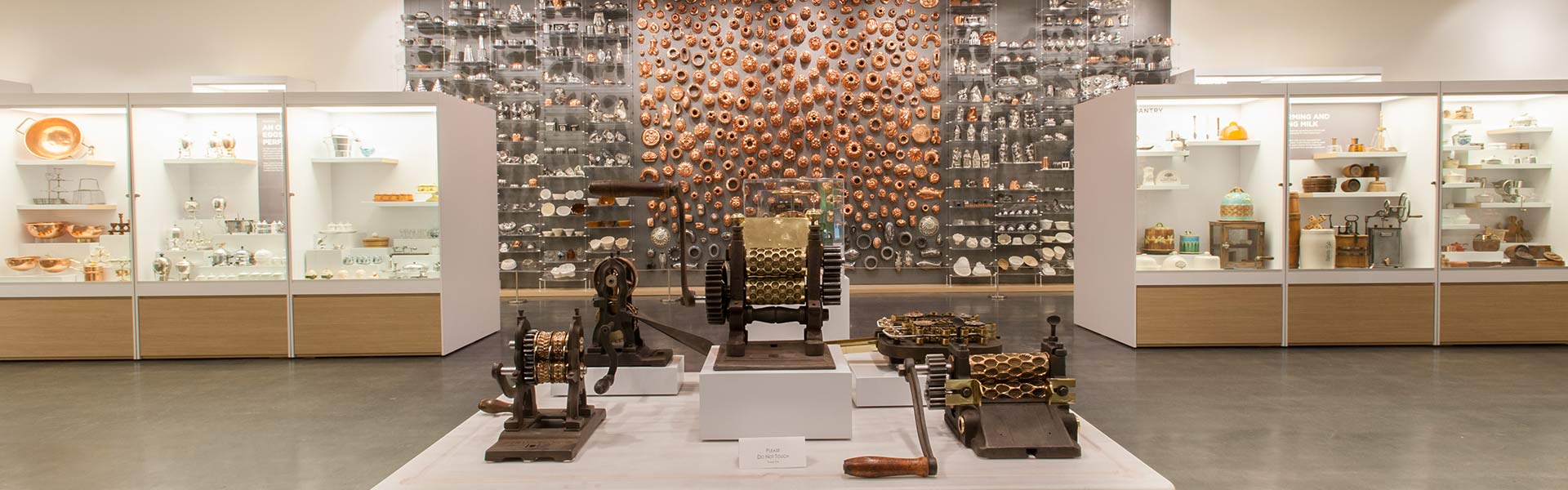 Interior of Chuck Williams Culinary Arts Museum showcasing historic cookware, tools, and kitchen artifacts.