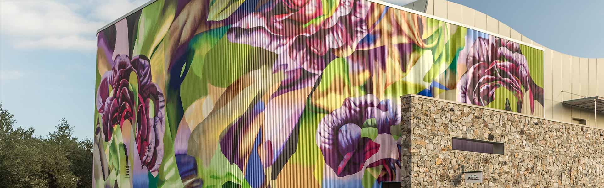 Colorful outdoor mural at CIA at Copia inspired by the culinary garden, featuring abstract lettuce artwork.