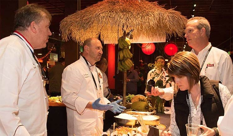 Chefs and attendees mingling at a CIA conference.