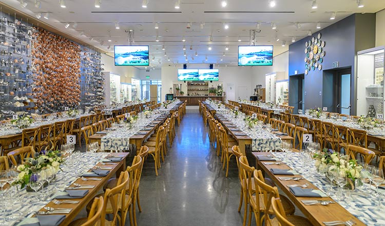 Long tables with blue runners and flowers at a private dining event at CIA at Copia in Napa, CA.