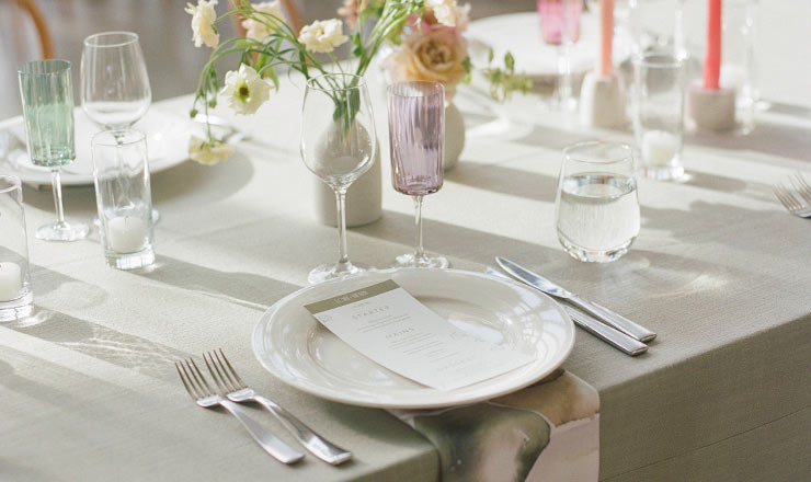 CIA at Copia wedding table with floral centerpiece, elegant place settings, and soft sunlight.