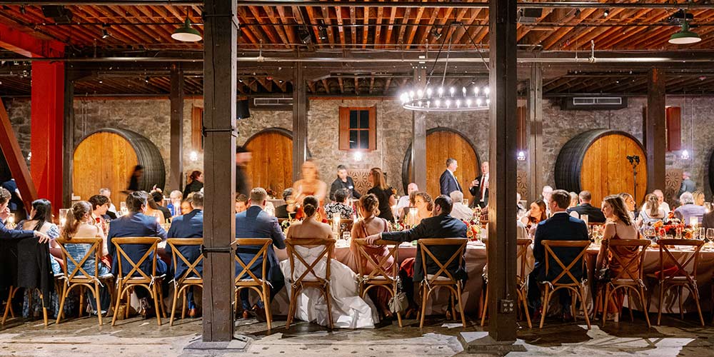 CIA at Greystone's Barrel Room hosting a wedding, with barrels, stone walls, wood beams.