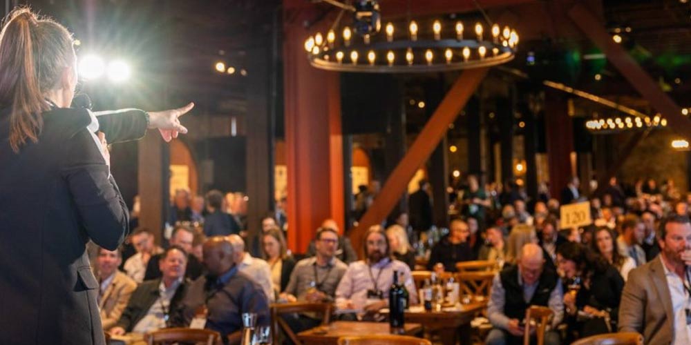 CIA at Greystone's Barrel Room venue hosting a gala, with barrels, stone walls, wood beams.