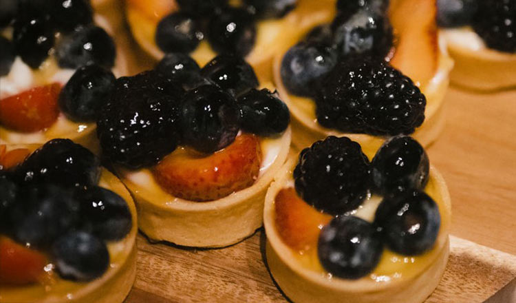 CIA at Greystone pastry tartlets topped with glossy blueberries, blackberries, and strawberries.